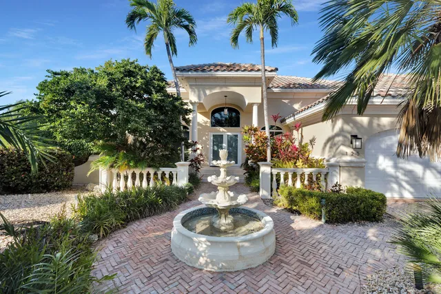 a view of a porch with potted plants and palm trees