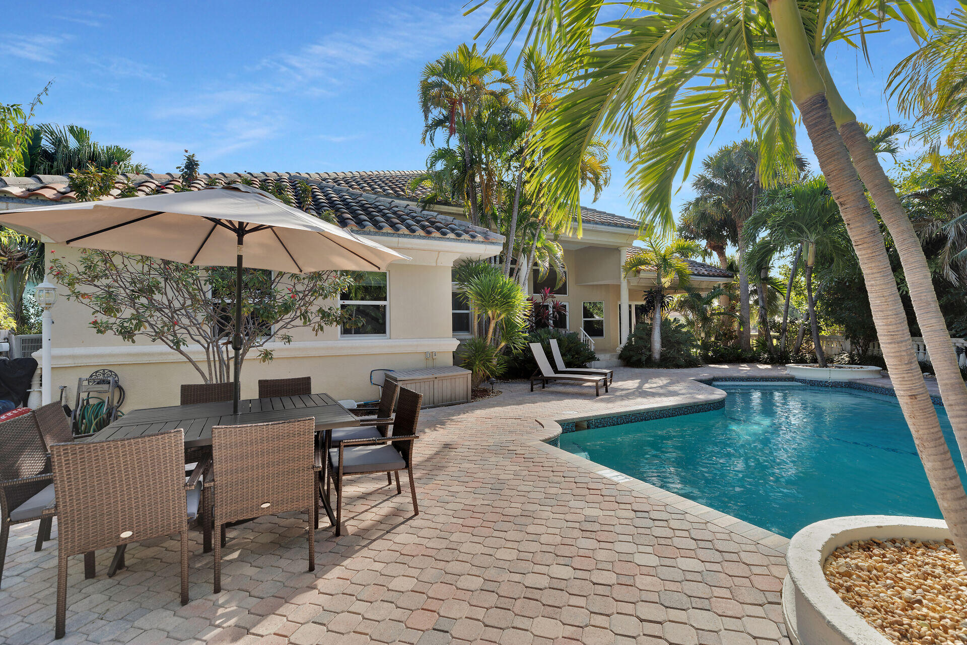 125 13th Street Key Colony Beach, FL 33051 - Photo 21 of 56 a view of a patio with chairs and a table under an umbrella