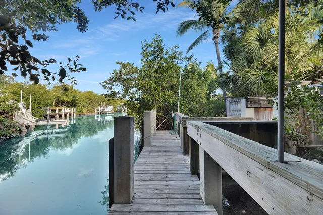 a view of a lake with chairs