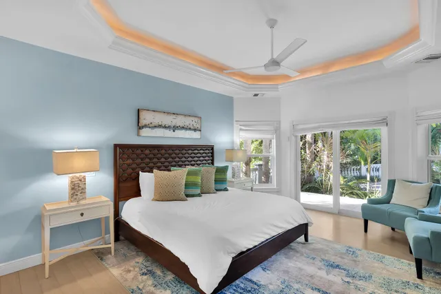 a bedroom with a large bed and a lamp