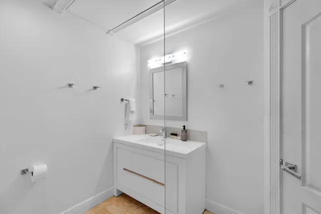 a bathroom with a glass shower door