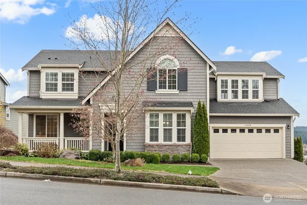 a front view of a house with a garden and plants