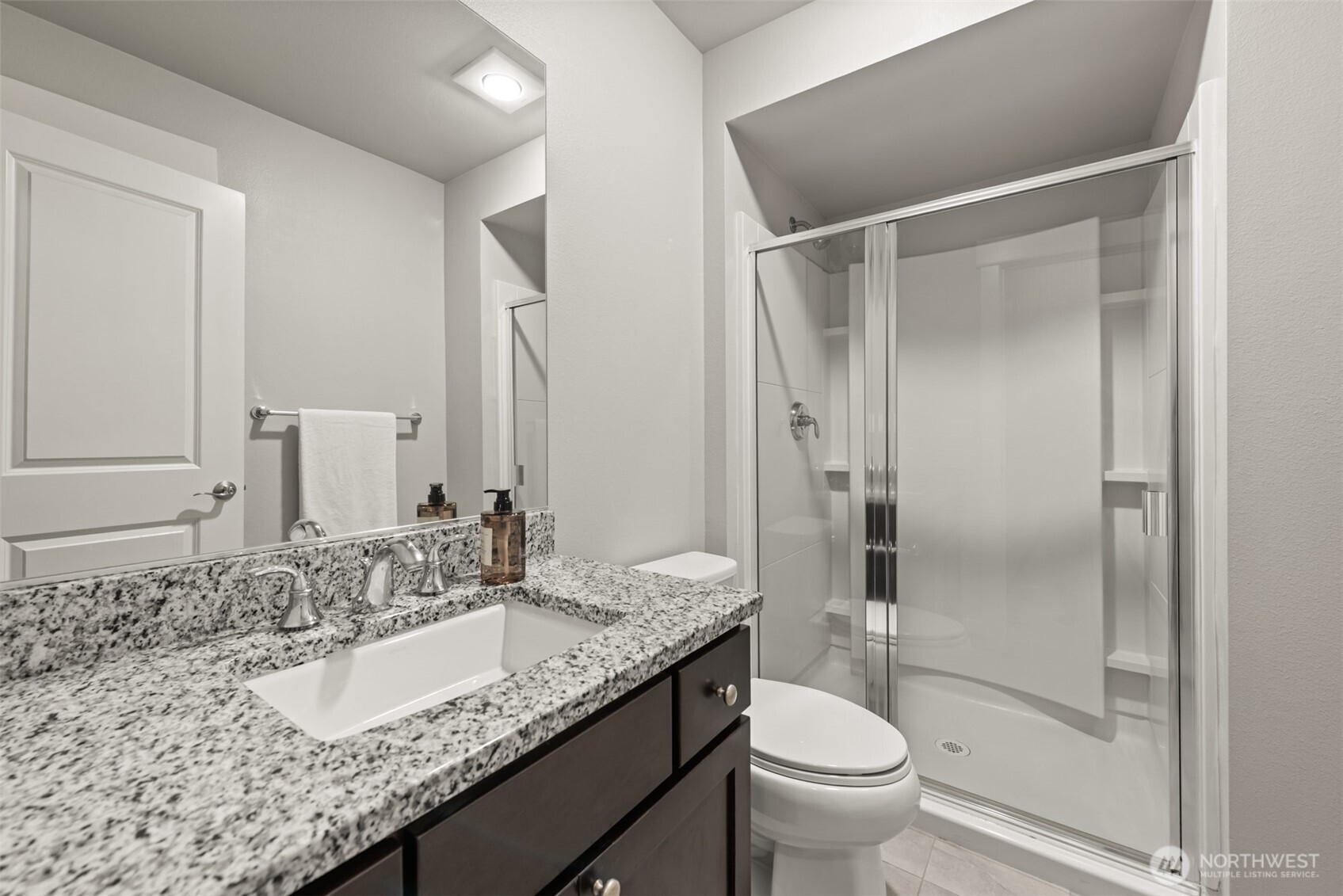 19420 109th Court Northeast Bothell, WA 98011 - Photo 21 of 35 a bathroom with a granite countertop sink toilet and shower