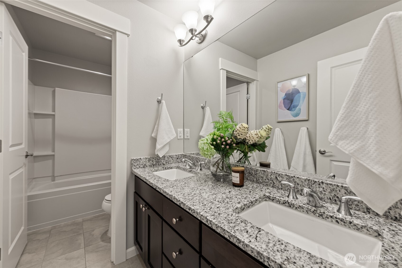 19420 109th Court Northeast Bothell, WA 98011 - Photo 25 of 35 a bathroom with a granite countertop sink and a mirror
