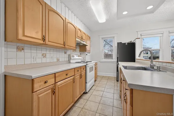 a kitchen with granite countertop a sink and cabinets