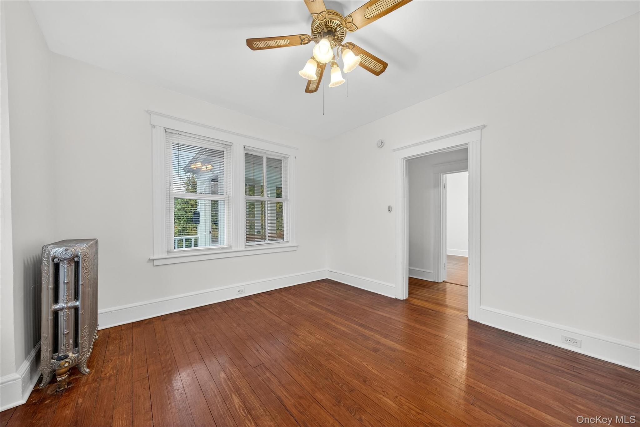 27 Algernon Street Cornwall, NY 12518 - Photo 8 of 41 an empty room with wooden floor chandelier fan and windows