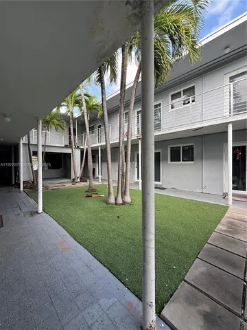 a view of a house with a yard and a garden