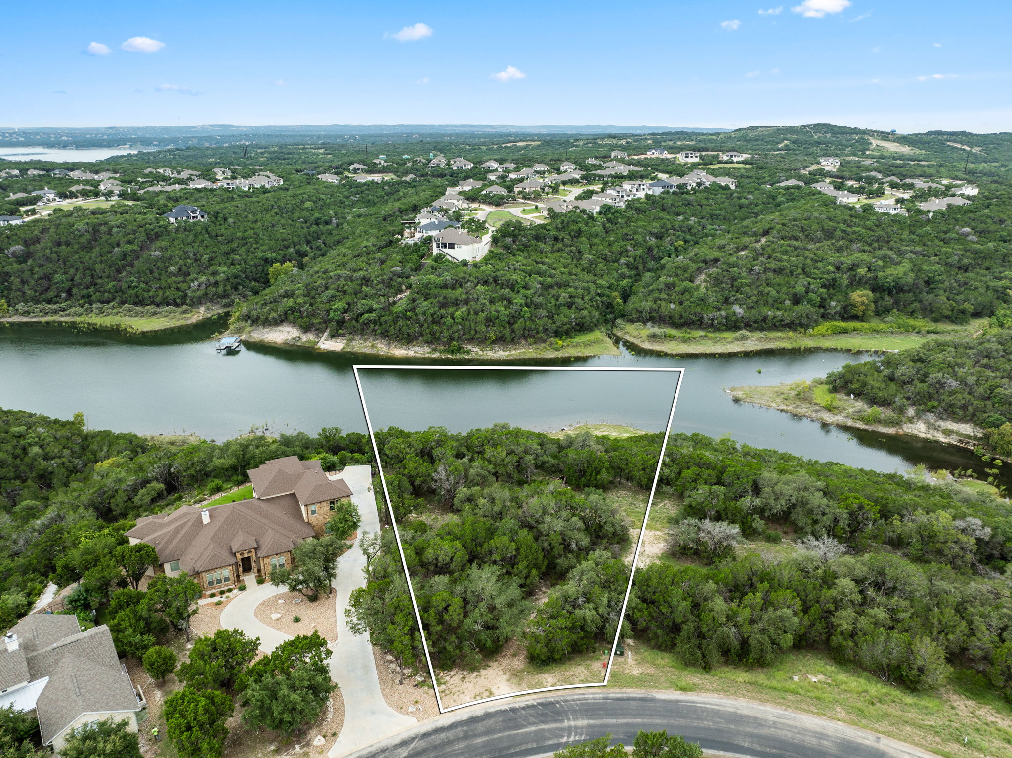 18821 Hidden Ridge Place Jonestown, TX 78645 - Photo 5 of 15 an aerial view of green landscape with trees houses and lake view