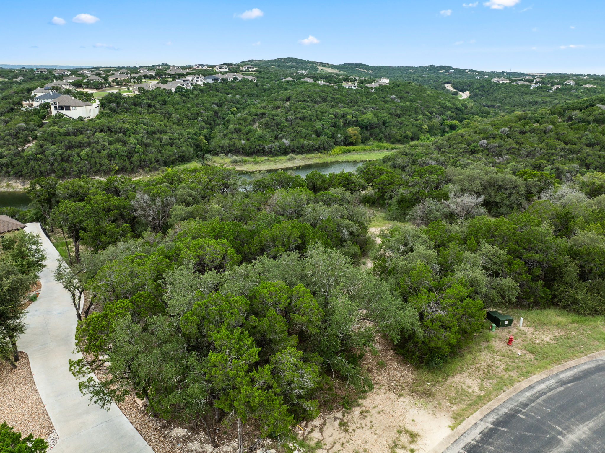 18821 Hidden Ridge Place Jonestown, TX 78645 - Photo 7 of 15 a view of a city with lush green forest