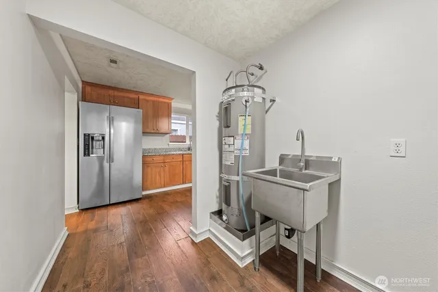 a view of a room with wooden floor table and chairs
