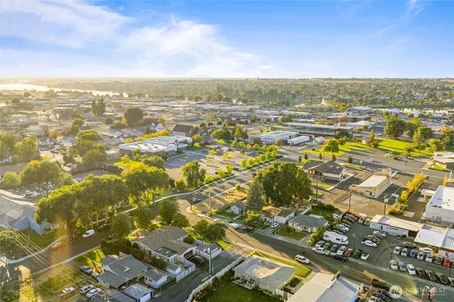 an aerial view of residential building with yard