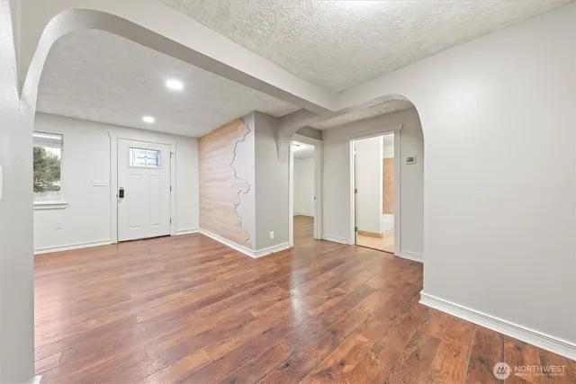 a view of an empty room with wooden floor