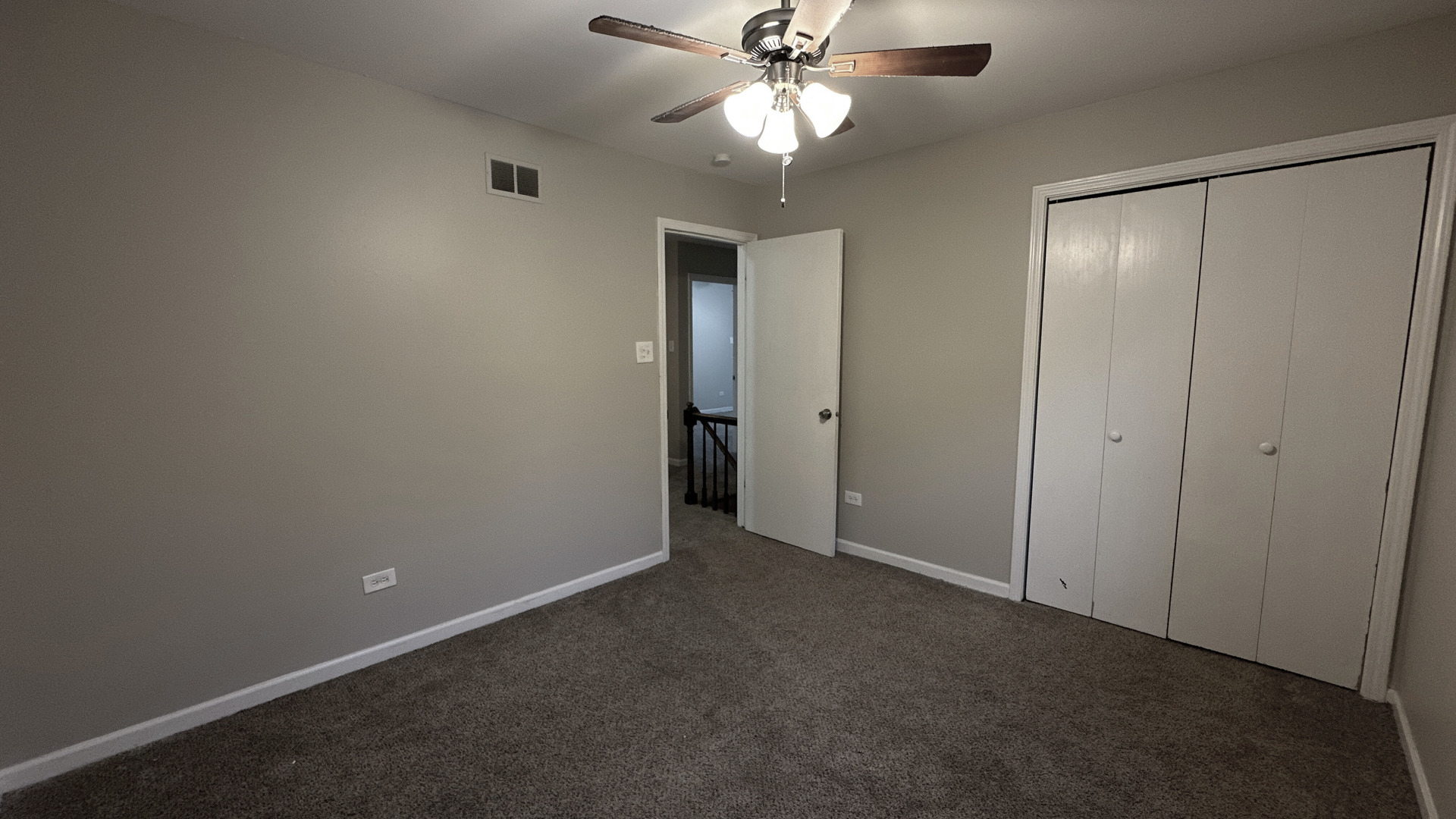 1607 Sylvan Court Flossmoor, IL 60422 - Photo 17 of 21 an empty room with closet and a chandelier fan