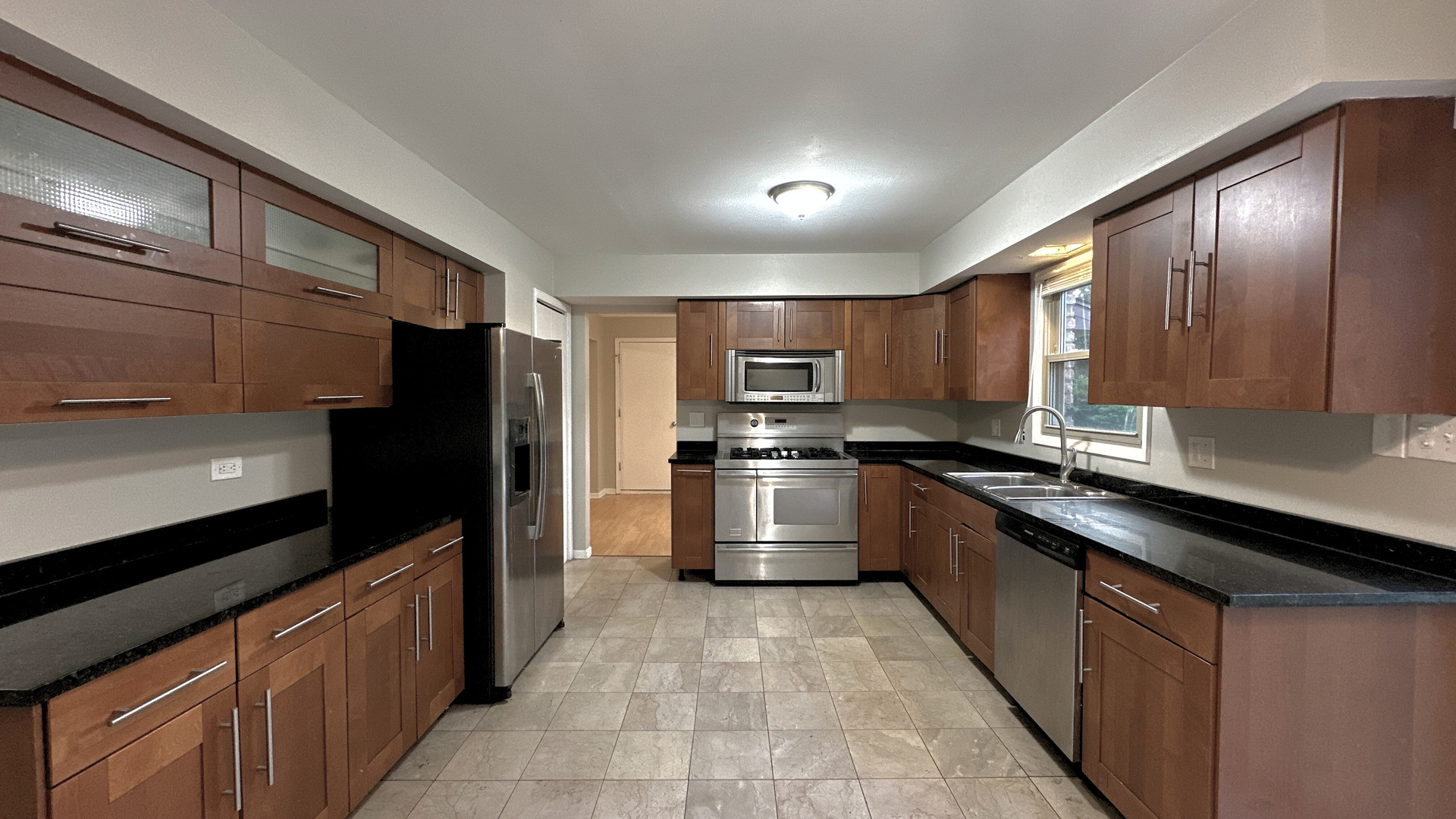 1607 Sylvan Court Flossmoor, IL 60422 - Photo 6 of 21 a large kitchen with stainless steel appliances kitchen island granite countertop a stove a sink and a refrigerator