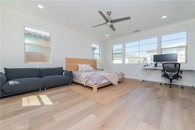 a bedroom with a bed window and couch