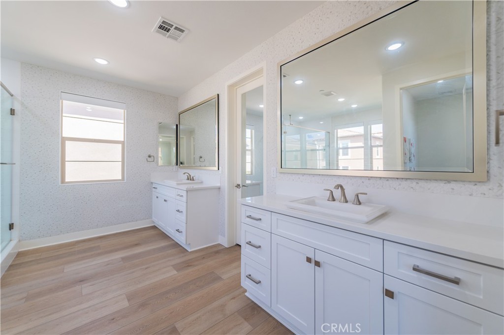 53 Lunar Irvine, CA 92618 - Photo 12 of 21 a bathroom with a double vanity sink and mirror with window