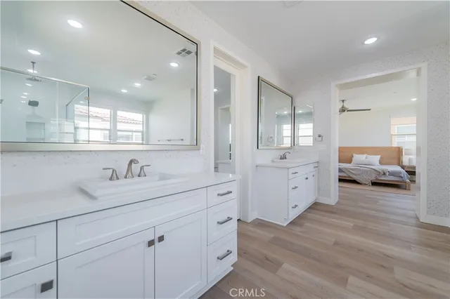 a spacious bathroom with a double vanity sink and mirror