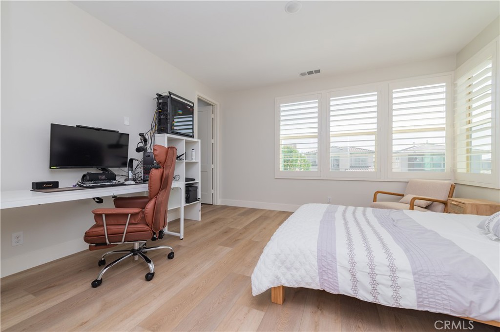 53 Lunar Irvine, CA 92618 - Photo 18 of 21 a bedroom with a bed and a flat screen tv