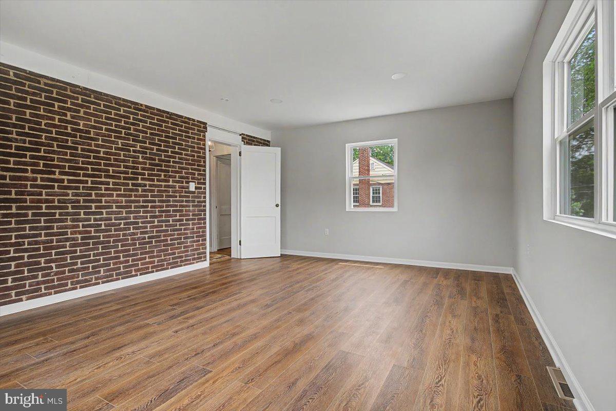 2202 Amhurst Road Wilmington, DE 19803 - Photo 21 of 33 Exposed brick wall in the primary bedroom