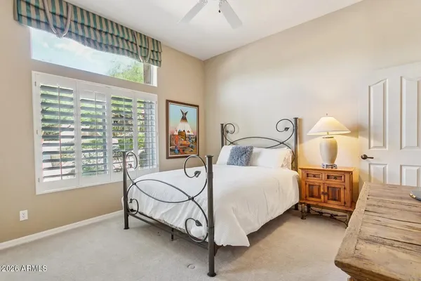 a view of room with window and a ceiling fan
