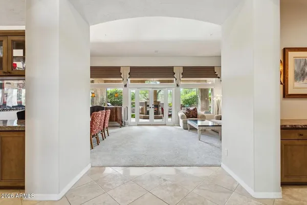 a view of an empty room with closet and a window