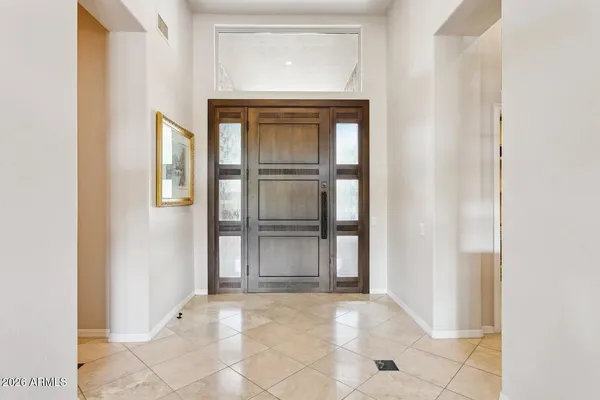 a kitchen with kitchen island granite countertop a sink cabinets and window