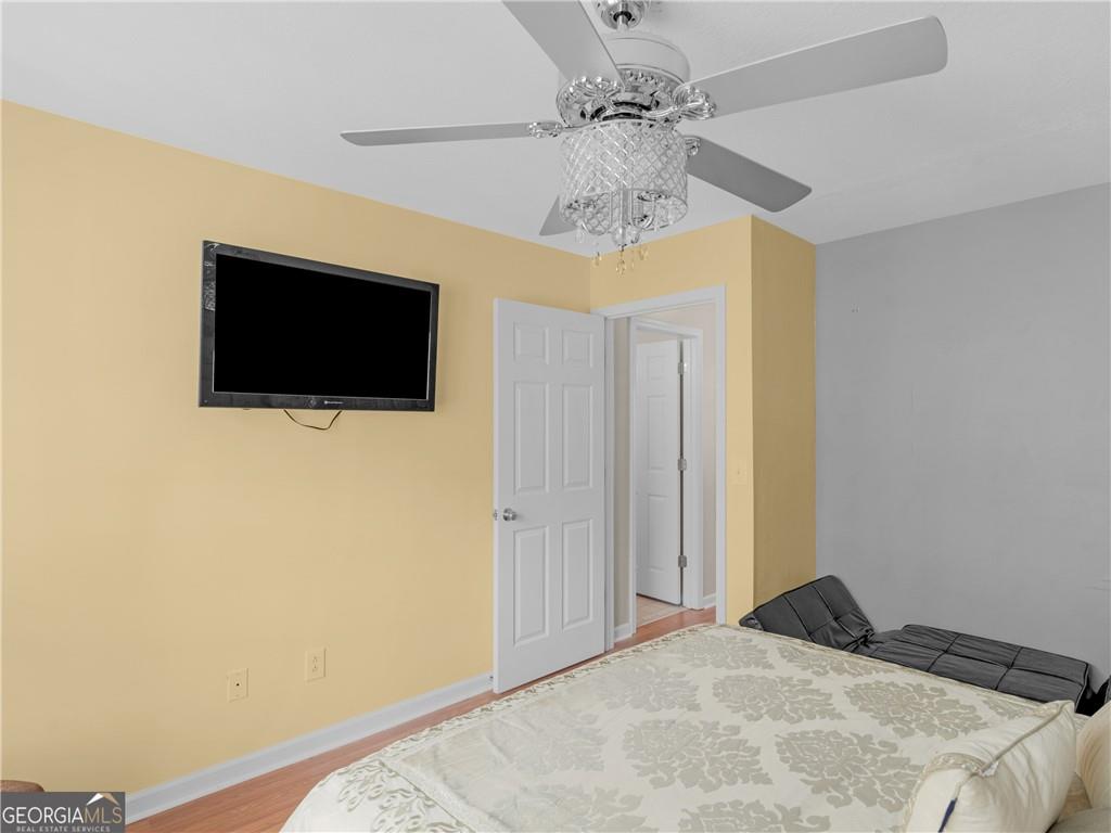 355 Parker Road Covington, GA 30014 - Photo 34 of 60 a bedroom with a bed and a flat screen tv