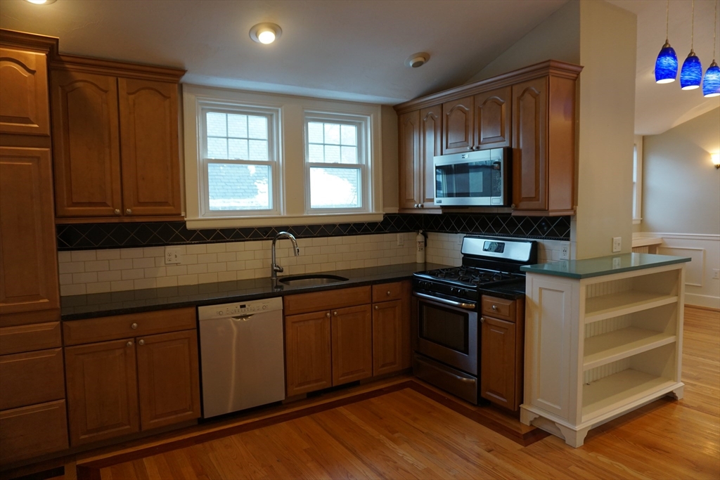 2 Littleton Road, Unit 3 Harvard, MA 01451 - Photo 11 of 19 a kitchen with stainless steel appliances granite countertop a stove a sink and a microwave