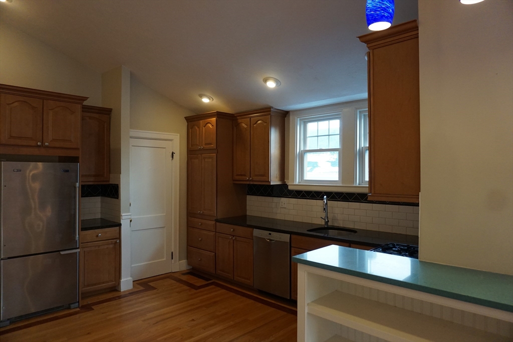 2 Littleton Road, Unit 3 Harvard, MA 01451 - Photo 12 of 19 a kitchen with kitchen island granite countertop a refrigerator and a sink