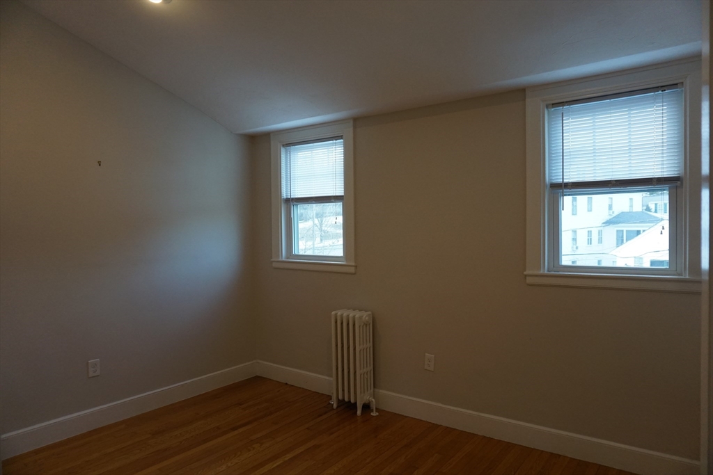 2 Littleton Road, Unit 3 Harvard, MA 01451 - Photo 15 of 19 an empty room with wooden floor and windows