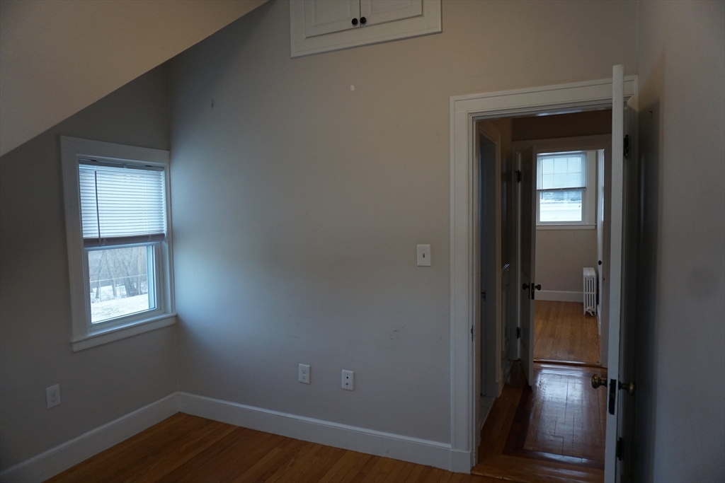 2 Littleton Road, Unit 3 Harvard, MA 01451 - Photo 17 of 19 an empty room with wooden floor closet and windows