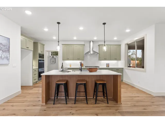 a kitchen with stainless steel appliances granite countertop wooden floors and sink