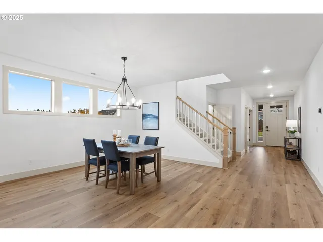 a large kitchen with cabinets table and chairs