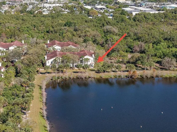 an aerial view of residential houses with outdoor space and river