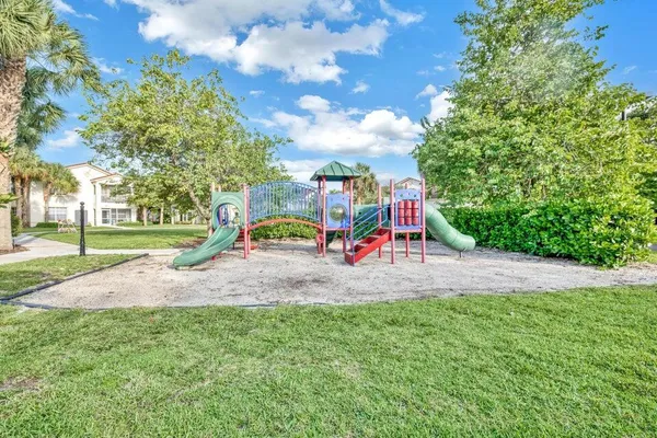 a view of outdoor space with playground and green space