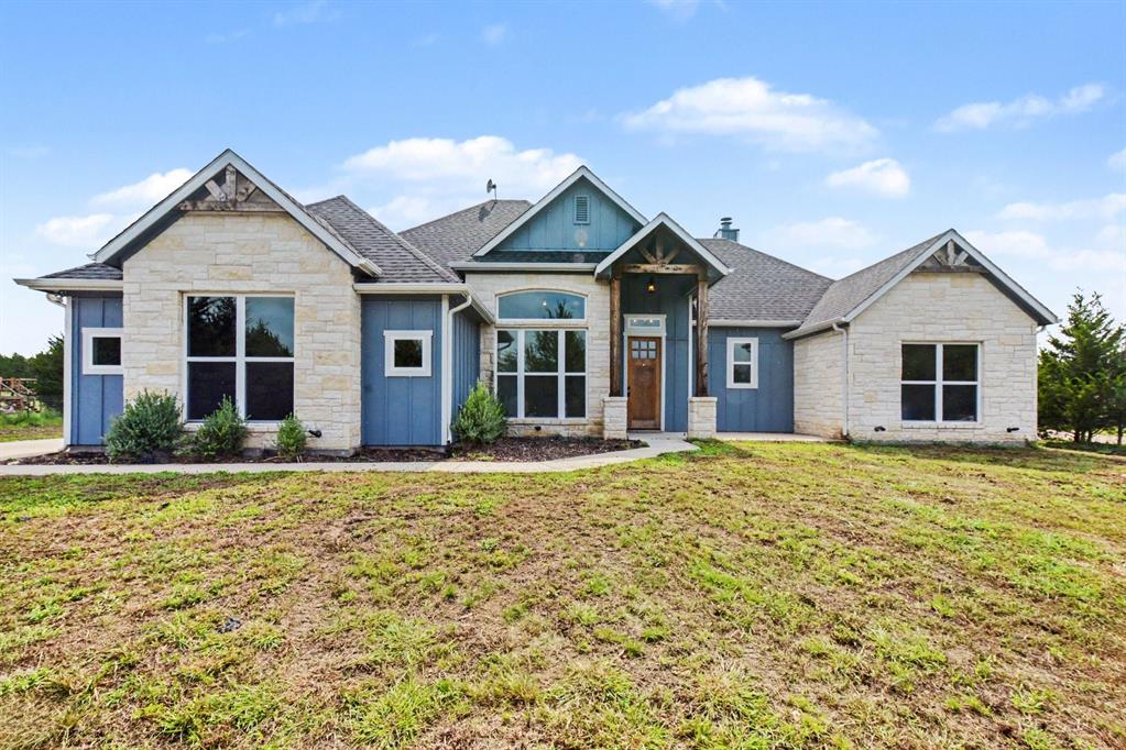 Contemporary exterior featuring light-colored stone accents and blue siding