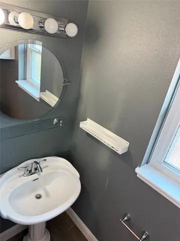 a bathroom with a sink a mirror and vanity