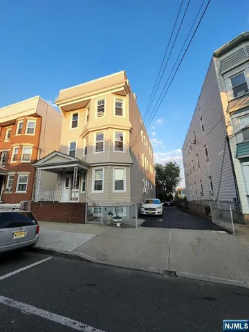a view of a street that has couple of cars parked on road