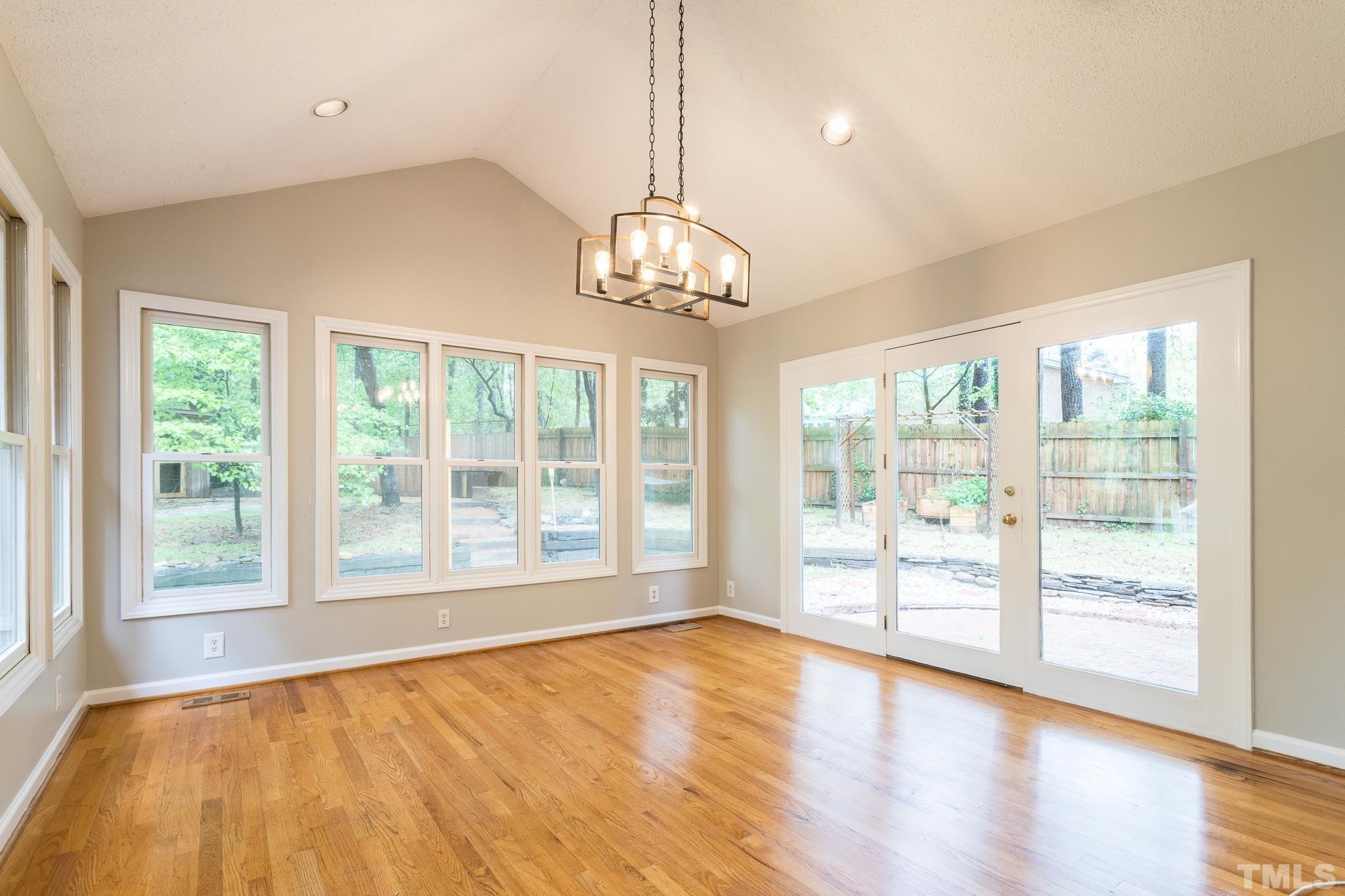 6216 Garrett Road Raleigh, NC 27606 - Photo 11 of 25 a view of an empty room with wooden floor and a window