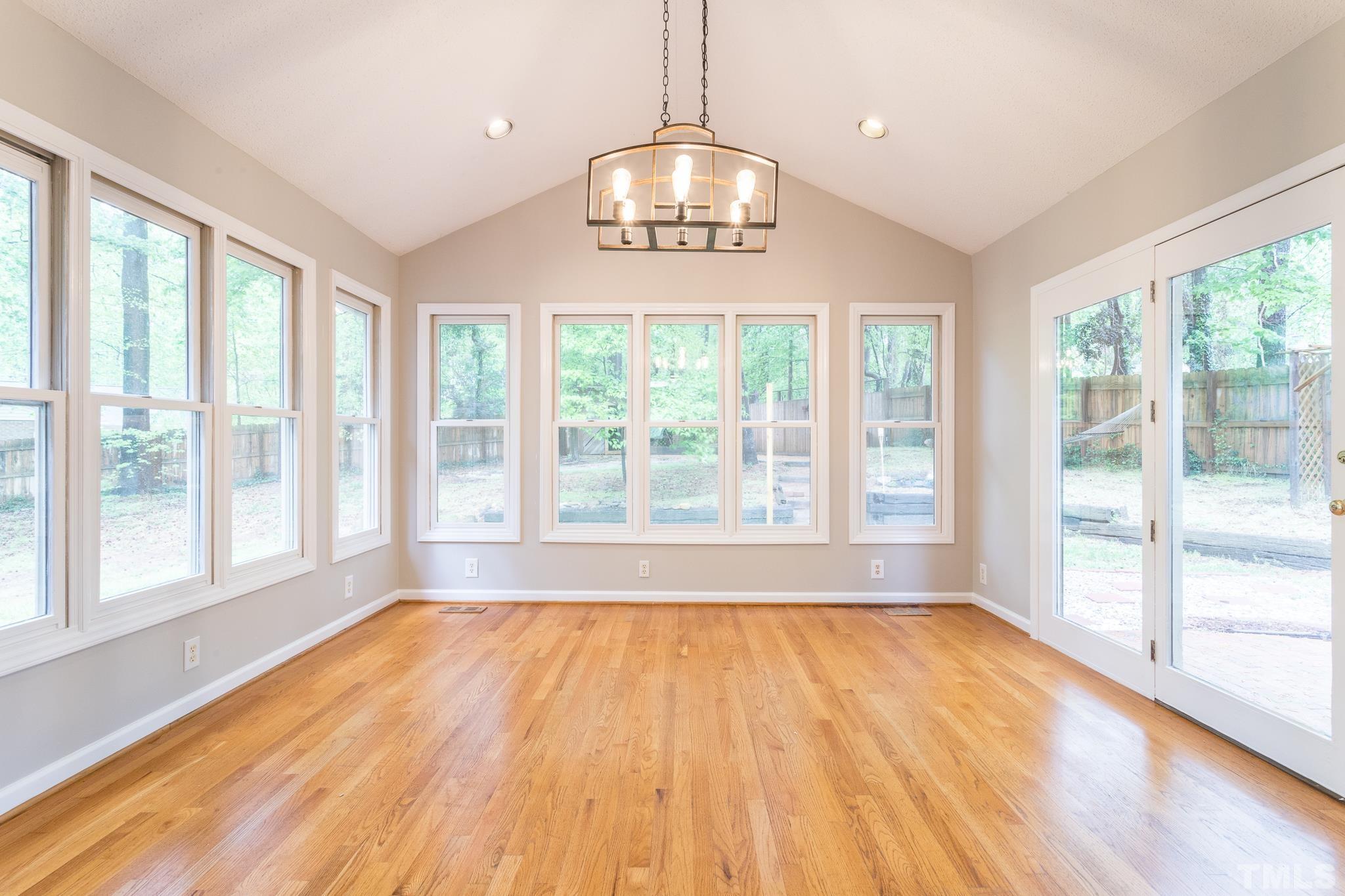 6216 Garrett Road Raleigh, NC 27606 - Photo 12 of 25 a view of an empty room with glass windows and a chandelier