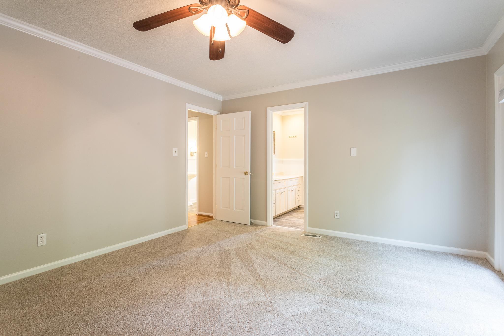 6216 Garrett Road Raleigh, NC 27606 - Photo 19 of 25 an empty room with chandelier fan