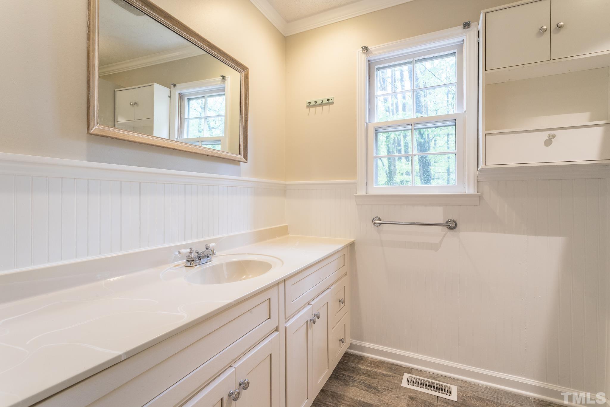 6216 Garrett Road Raleigh, NC 27606 - Photo 20 of 25 a bathroom with a sink and a window