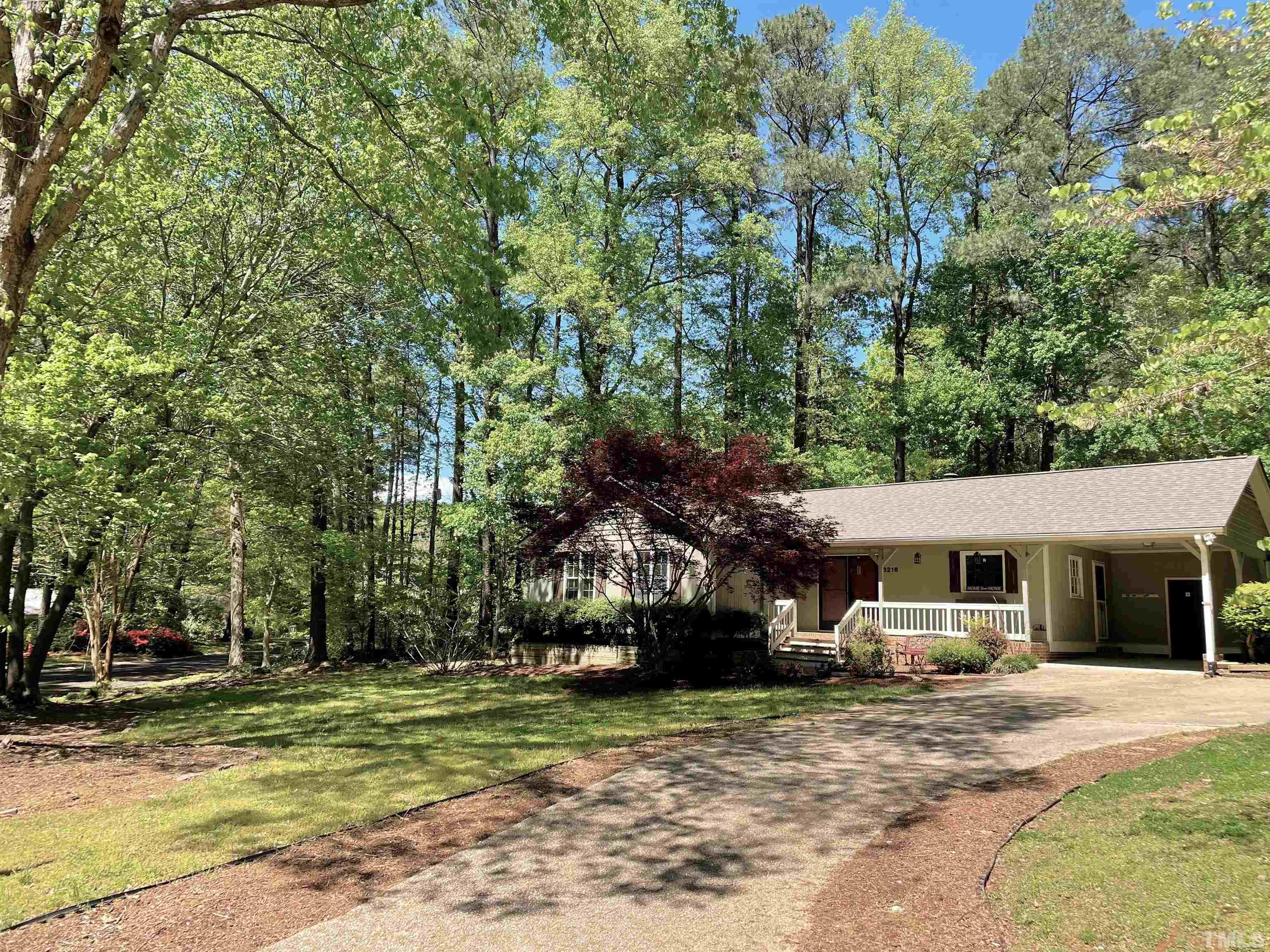 6216 Garrett Road Raleigh, NC 27606 - Photo 2 of 25 a front view of a house with a garden