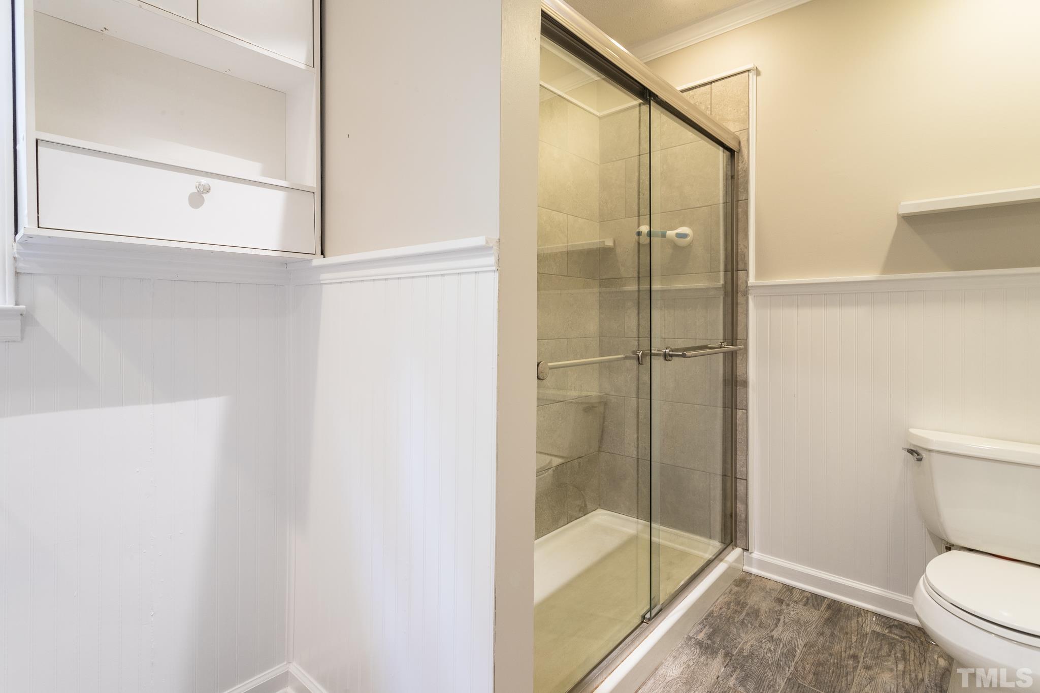 6216 Garrett Road Raleigh, NC 27606 - Photo 21 of 25 a bathroom with a shower and toilet