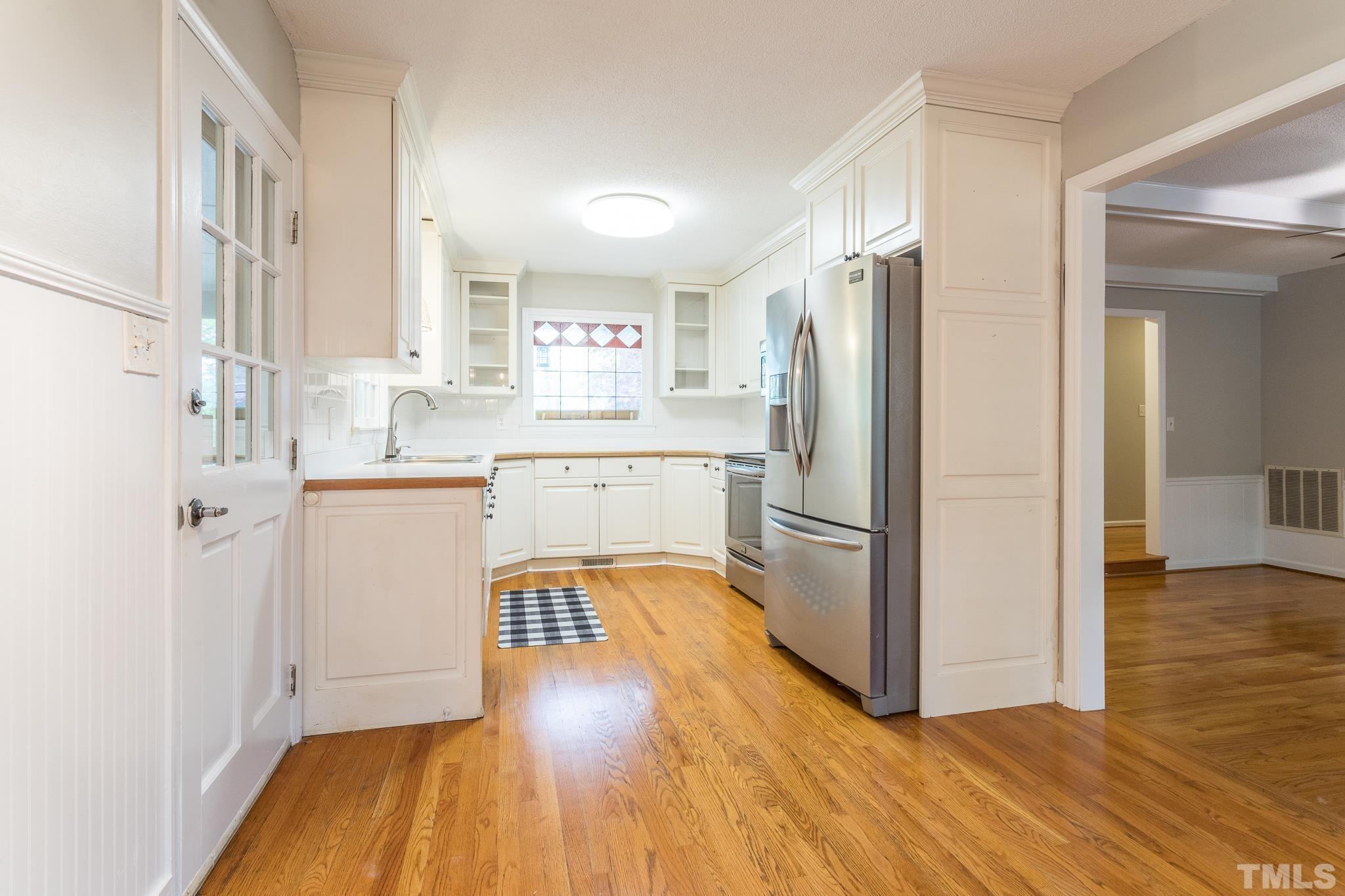 6216 Garrett Road Raleigh, NC 27606 - Photo 8 of 25 a kitchen with a refrigerator sink and cabinets