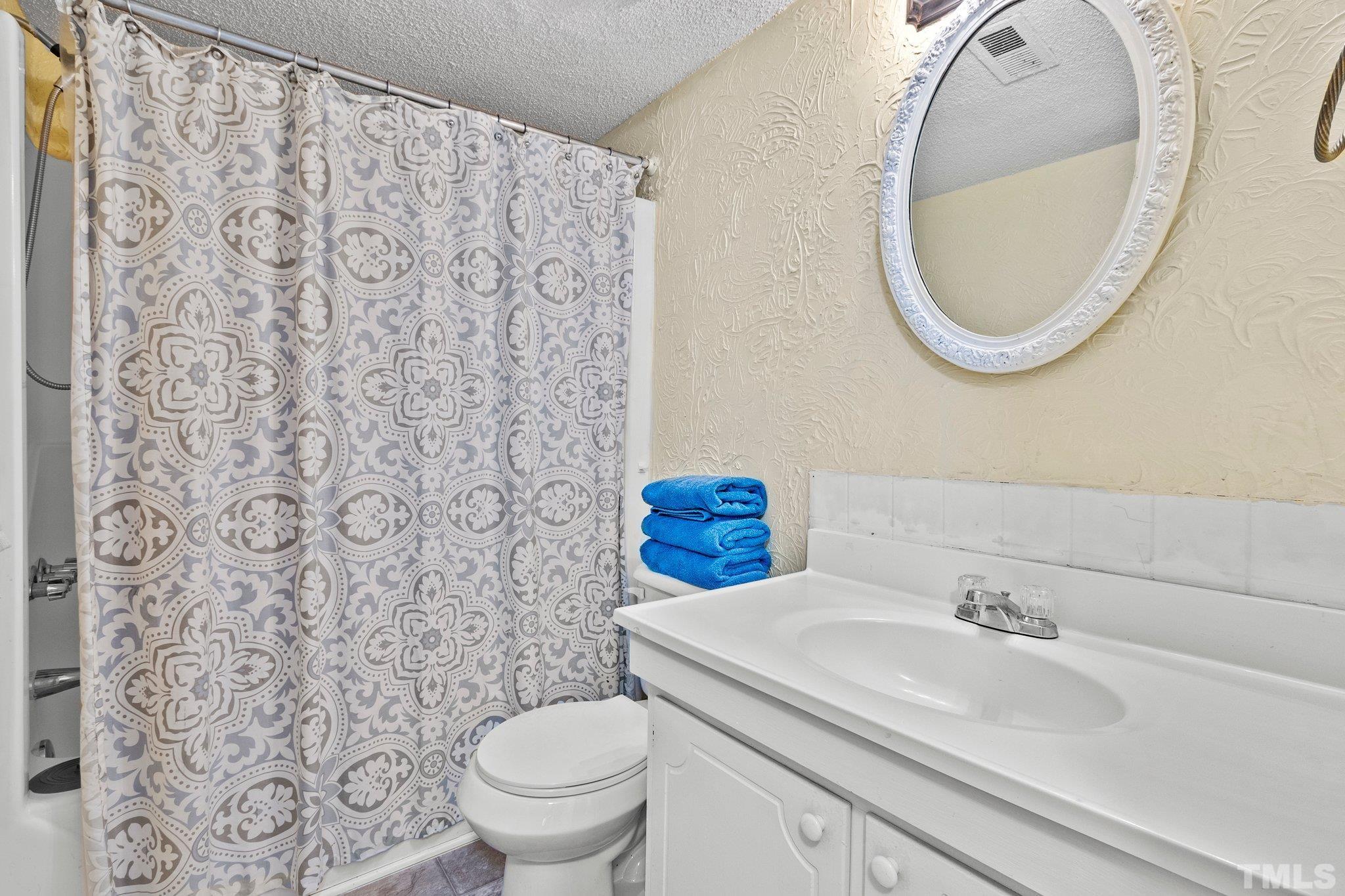 667 Pine Ridge Place, Unit 667 Raleigh, NC 27609 - Photo 18 of 37 a bathroom with a sink and a mirror