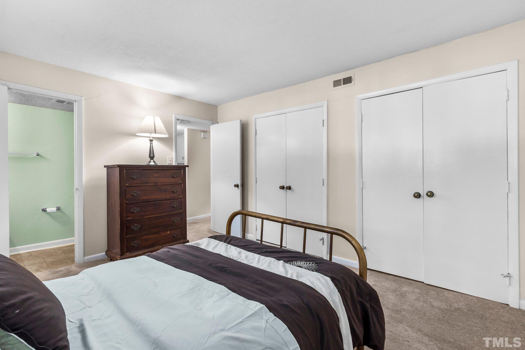 667 Pine Ridge Place, Unit 667 Raleigh, NC 27609 - Photo 21 of 37 a bedroom with a bed and closet