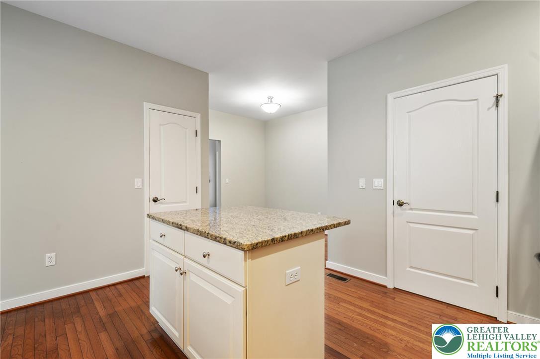 6022 Eli Circle Macungie, PA 18062 - Photo 12 of 29 a bathroom with a granite countertop sink and a mirror