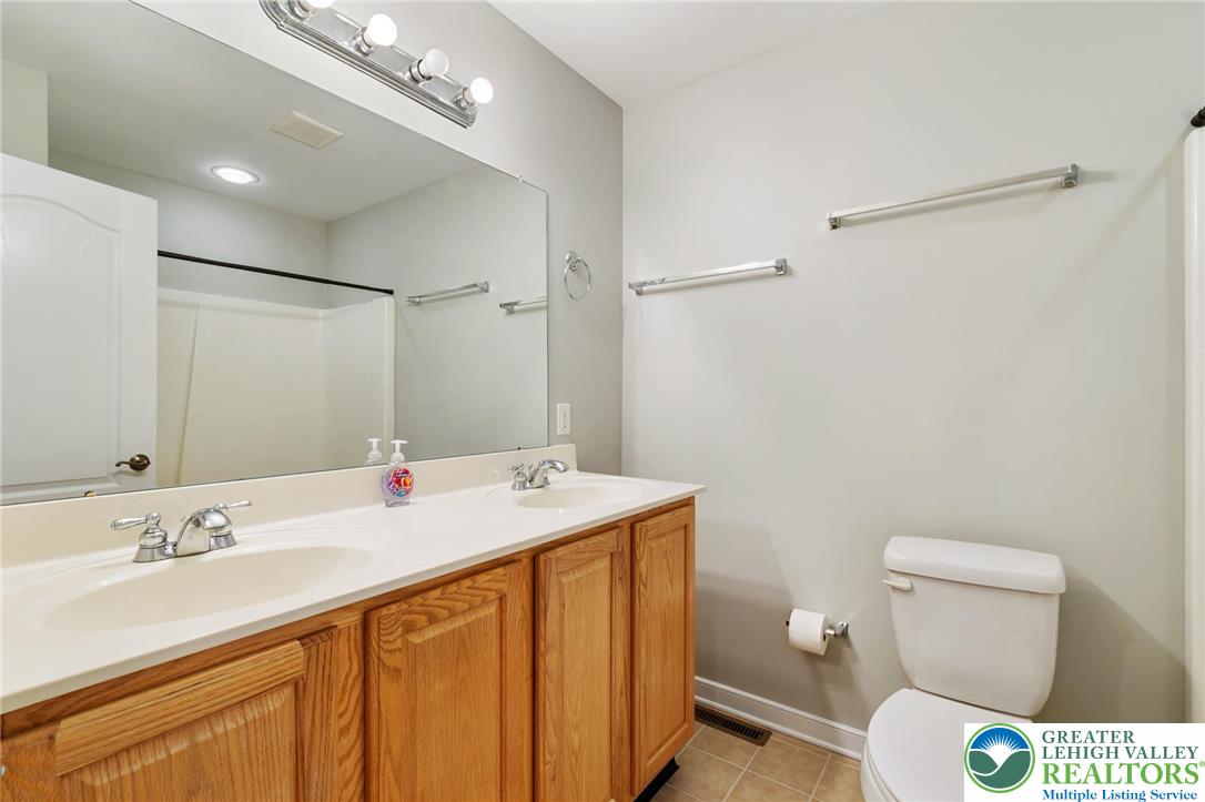 6022 Eli Circle Macungie, PA 18062 - Photo 24 of 29 a bathroom with a sink a toilet a mirror and shower