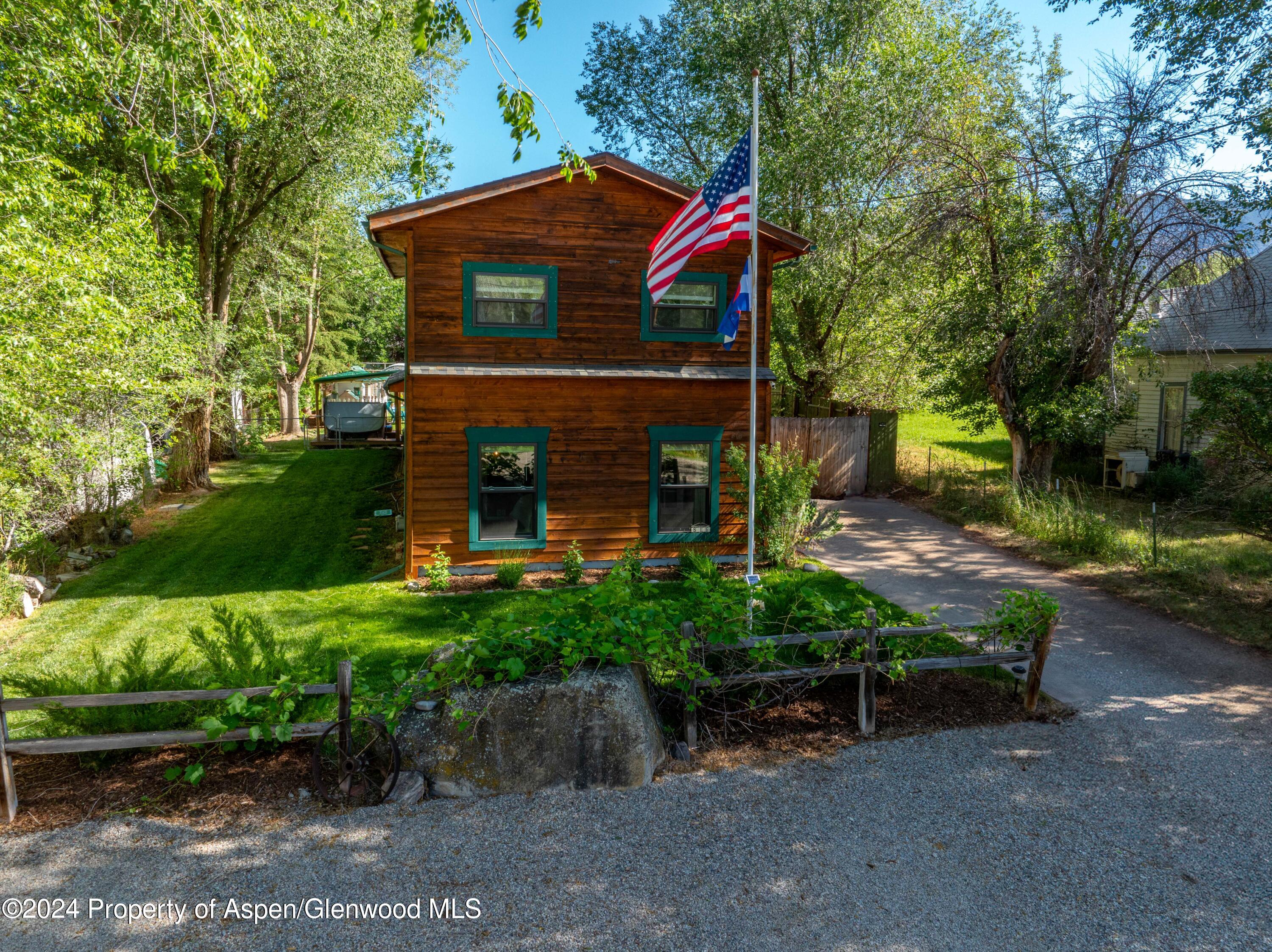 816 East 2nd Street New Castle, CO 81647 - Photo 1 of 32 a front view of a house with garden
